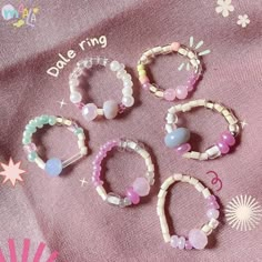 several different bracelets and rings on a pink cloth with the words dole ring written above them