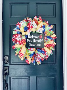 a welcome sign is attached to the front door of a classroom classy decorated wreath