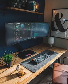 a desk with two computer monitors and a keyboard on it, along with a plant