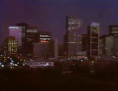 the city skyline is lit up at night, and it appears to be very blurry