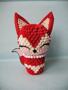 a red and white fox head made out of paper