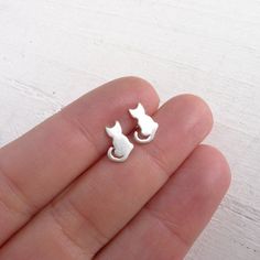 "Little Sterling Silver cat shapes are soldered to sterling silver posts to create these tiny stud earrings. . { m e a s u r e m e n t s } . ~ 1/3\" . { o p t i o n s } . Other Post Earring Styles: https://www.etsy.com/shop/CamileeDesigns?section_id=10245147&ref=shopsection_leftnav_3 . { p a c k a g i n g } . Your jewelry will arrive in a cute box - perfect for giving or keeping for yourself. . { s h i p p i n g } . Handmade in my studio shipped via USPS mail with tracking. Please see shippi Sterling Silver Cat Design Earrings For Gift, Cat Stud Earrings, Gifts For Cat Lovers, Cat Earrings Studs, Sterling Silver Cat, Silver Cat, Tiny Stud Earrings, Cat Jewelry, Earring Posts