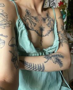 a woman with tattoos on her arms and chest