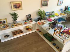 a child's playroom with toys and pictures on the wall