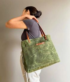 Green Rectangular Canvas Bag For Outdoor, Green Tote Canvas Bag For Outdoor, Green Canvas Tote Bag For Outdoor Use, Coated Canvas Tote Bag With Pockets, Green Waxed Canvas Bags With Pockets, Practical Rectangular Waxed Canvas Bag, Practical Rectangular Canvas Bag With Waxed Finish, Casual Everyday Canvas Bag With Waxed Finish, Green Tote Shoulder Bag For Outdoor