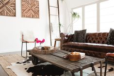 a living room with leather couches and wooden tables