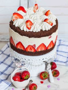 a large cake with strawberries on top