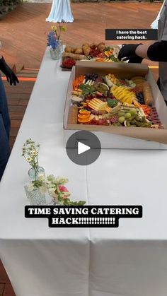 two people standing next to a table with food on it and the words time saving catering hack