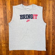 Dope tank top from the early '00s. Big spellout and logo on front. Has some faint staining on the "B" and "R" otherwise in good condition. Tagged an XL but fits more like a L.  Brand: Nike Size: L Color: Gray, Black, Red Condition: Good Y2k Sleeveless Letter Print T-shirt, Y2k Sleeveless T-shirt With Letter Print, Pre-shrunk Cotton Sleeveless T-shirt, Tank T-shirt With Letter Print For Streetwear, Y2k Sleeveless T-shirt For Streetwear, 90s Letter Print Tank Top For Streetwear, Cotton Letter Print Vest For Streetwear, Cotton Vest With Letter Print For Streetwear, Sleeveless Screen Print Tops For Streetwear