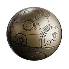 a metal ball with circles and lines on the outside, sitting in front of a white background