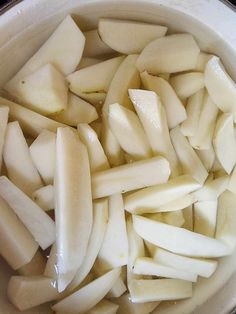 sliced apples are sitting in a pot on the stove top, ready to be cooked