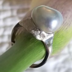 "* This beautiful pearl ring would be a wonderful gift to a bride on her wedding day, or perhaps the mother of the bride or groom! The silvery gray pearl is is unique and beautful, giving this ring tons of understated charm and elegance. This ring is very sturdy and well-made, and it shows! * This piece weighs 6.7 grams, and is stamped \"14K\" inside the shank. The pearls measure approximately 12.6 mm x 12.9 mm This ring is a US size 7. Please message us about sizing options prior to purchase! * Modern Pearl Wedding Ring, Silver Akoya Pearl Ring For Anniversary, Silver Akoya Pearl Drop Ring, Silver Akoya Pearl Ring With Pearl Drop, Minimalist Silver Pearl Wedding Ring, Silver Pear-shaped Rings For Formal Occasions, Pear-shaped Silver Rings For Formal Occasions, Modern Wedding Pearl Ring In Sterling Silver, Modern Silver Pearl Wedding Ring