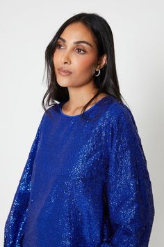 The sequin top is a stylish and glamorous addition to your wardrobe. With its glittery sequins and round neck design, it adds a touch of sparkle to any outfit. The long sleeves and puff sleeve detail give it a trendy and fashionable look. Perfect for a night out or special occasion, this top is sure to make you stand out in the crowd. Occasion Dresses Wedding Guest, Petite Jumpsuit, Round Neck Design, Balloon Sleeve Top, Petite Coat, Tall Clothing, Tshirt Skirt, Petite Tops, Sequin Top