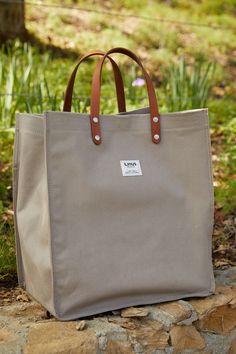 a gray bag sitting on top of a stone wall