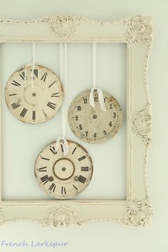 three clocks are hanging on the wall