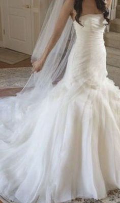 a woman wearing a wedding dress and veil