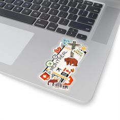 a laptop computer with stickers on the keyboard