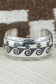 This sterling silver bracelet was made by Navajo silversmith Rosita Singer. The back is signed T&R Singer and stamped sterling.Size: 5 1/2" (will fit a 6 3/4" wrist)Gap: 1 1/4"Length: 1 1/4"Free shipping on all orders! We ship with USPS and always include tracking. All orders ship within a day of payment.Returns are accepted up to 30 days after you receive your order. Just send us a message. Our shop offers cash back or store credit. The item must be returned in new condition. Silver Southwestern Stamped Bracelets, Silver Stamped Southwestern Bracelets, Southwestern Stamped Silver Bracelets, Southwestern Style 925 Silver Bracelets, Sterling Silver Southwestern Bracelet, Southwestern Sterling Silver Bracelet, Handmade Southwestern Silver Bracelets, Navajo Bracelet, Sterling Silver Bracelet