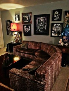 a living room filled with furniture and pictures on the wall