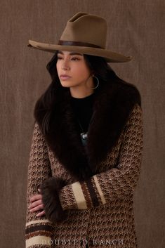 WE’RE HEAD OVER HEELS FOR THIS HEAD-TURNER! Say hello to this season’s statement duster. The beautiful blend of browns in this chic southwestern design highlight the horse in profile emblazoned on the back. And if the full length wasn’t fabulous enough for you, it’s trimmed in luxe voluminous rabbit fur! color: multi content: 64% poly, 30% nylon, 6% wool collar: rabbit fur embellishments: custom print size: XS-2X fit: classic straight fit, ankle length with deep side slits style number: C3365 co Luxury Western Brown Outerwear, Southwest Duster, Luxury Western Suede Outerwear, Micro Suede Women’s Duster, Western Coats & Jackets, Double D Ranch, Head Over Heels, Southwestern Design, Vest Top