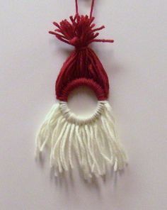 a red and white tassel hanging on a wall