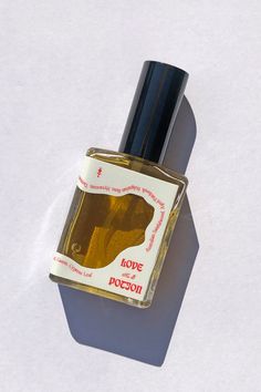 a bottle of perfume sitting on top of a white surface