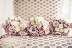 the bridesmaids carried bouquets of pink and white roses on their wedding day