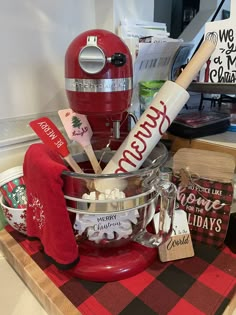 a red mixer sitting on top of a counter next to other kitchen items and utensils