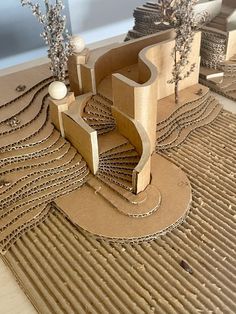 an architectural model made out of cardboard on a table