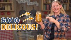 a woman holding up a jar filled with liquid in front of a sign that says $ 5000 delicious