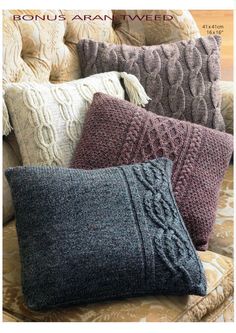 three knitted pillows sitting on top of a couch in front of a phone screen