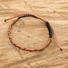 a close up of a bracelet on a wooden surface