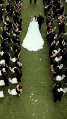 a bride and groom walking down the aisle at their wedding ceremony in an aerial photo