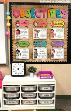 a bulletin board and some bins in front of it