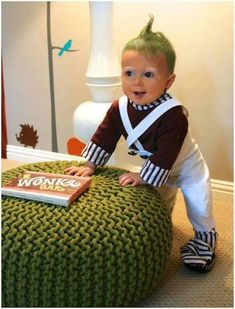 a little boy that is sitting on top of a ottoman