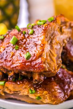 ribs covered in bbq sauce and garnished with green onions