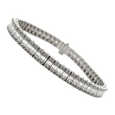 14K white gold tennis bracelet with 232 round brilliant-cut diamonds weighing 1.57 carats total and 174 straight baguette diamonds weighing 3.05 carats total. * 7 inches long * G/H color, SI clarity Baguette Diamond Bracelet, Gold Tennis Bracelet, Bracelet Tennis, Diamond Tennis Bracelet, Baguette Diamonds, Tennis Bracelet Diamond, Baguette Diamond, Tennis Bracelet, Round Brilliant Cut Diamond