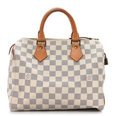 This is an authentic LOUIS VUITTON Damier Azur Speedy 25. This iconic tote is crafted of Louis Vuitton Damier checkered canvas in blue and white. The handbag features natural vachetta cowhide leather trim and rolled top handles with polished gold tone handle rings. The top zipper opens to a beige fabric interior with a hanging pocket. Damier Azur Speedy, Speedy 25, Louis Vuitton Damier Azur, Beige Fabric, Authentic Louis Vuitton, Leather Trim, Cowhide Leather, Louis Vuitton Damier, Leather Trims