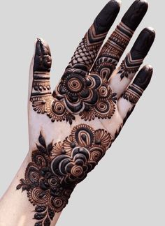 a hand with henna on it that is showing the intricate pattern and design,