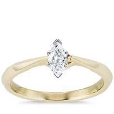 a yellow gold engagement ring with an oval cut diamond