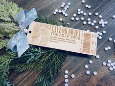 a wooden ticket sitting on top of a table covered in white and blue candies