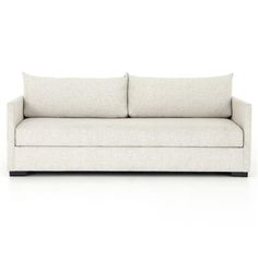 a white couch with two pillows on it