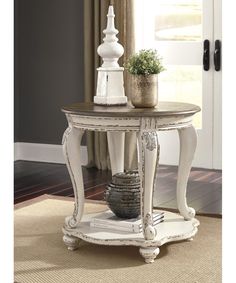 a table with a potted plant on top of it next to a door way