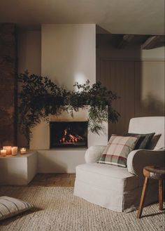 a living room with a chair, fireplace and potted plant