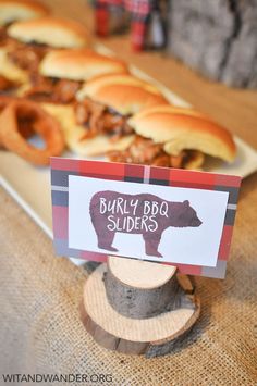 there is a sign that says bubbly bbq sliders on the table with buns in the background