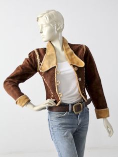 "This 1970s vintage, custom leather jacket has bold rock n' roll style. The rare find, was hand crafted and features whip-stitch and braid detailed seams. It fits cropped and fitted with slightly puffed shoulders. Dark brown suede shapes the jacket with yellow leather detailing on the big collar and rolled cuffs. Princess seams down the bust are detailed with cross-stitches. The jacket closes with 3 horn buttons, and opens to a fully lined interior. CONDITION In great condition with wear consist Western Style Fitted Leather Jacket For Winter, Fitted Western Leather Jacket For Winter, Vintage Outerwear With Contrast Stitching For Fall, Fitted Leather Jacket With Contrast Stitching For Fall, Vintage Winter Outerwear With Contrast Stitching, Vintage Outerwear With Contrast Stitching For Winter, Fitted Leather Jacket With Contrast Stitching, Western Brown Fitted Leather Jacket, Fitted Retro Leather Jacket For Fall