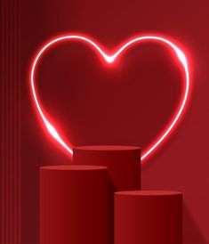 a heart shaped neon sign sitting on top of a red wall next to two stools