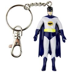 a batman keychain is shown next to a pair of scissors