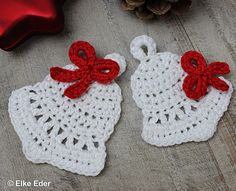 two crocheted white and red doily with bows on them next to a christmas ornament