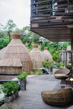 an outdoor area with wicker furniture and potted plants